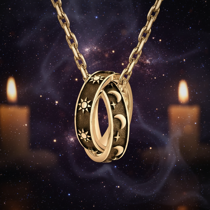A silver-toned interlocking pendant necklace featuring celestial motifs, including suns, crescent moons, and stars, shown on a plain white background.