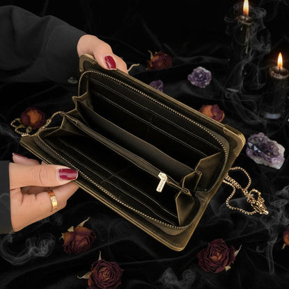 Black wallet held open by a hand on a textured surface
