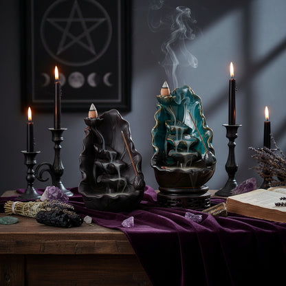Two incense burners with waterfalls on a gray background