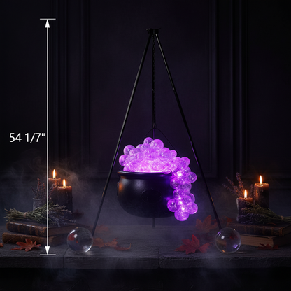 Black hanging cauldron decoration filled with glowing purple beads, suspended from a tripod stand, with a height measurement of 54 1/7 inches shown on a white background.