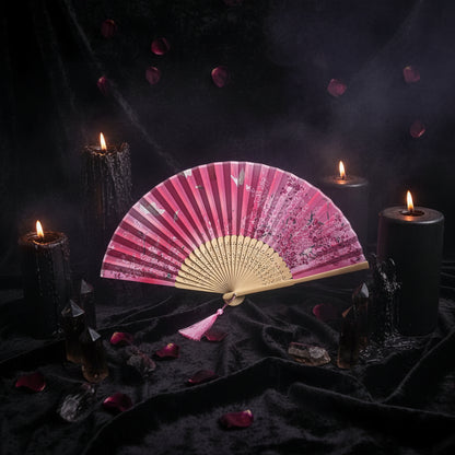 Pink floral folding fan with tassel on a white background with pink flowers