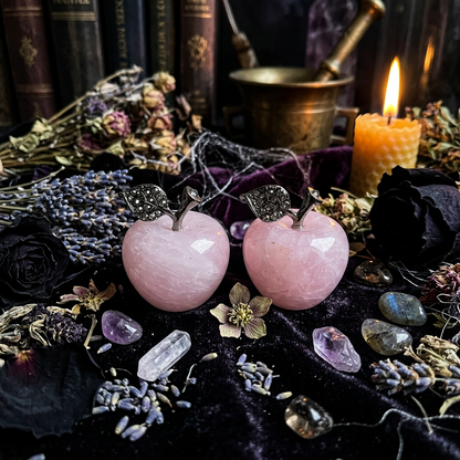 Pink apple-shaped earrings with silver leaves on a white surface