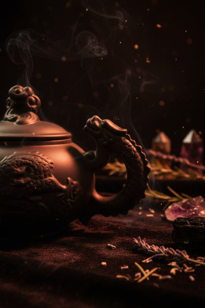 Black ceramic teapot with dragon handle on a white background