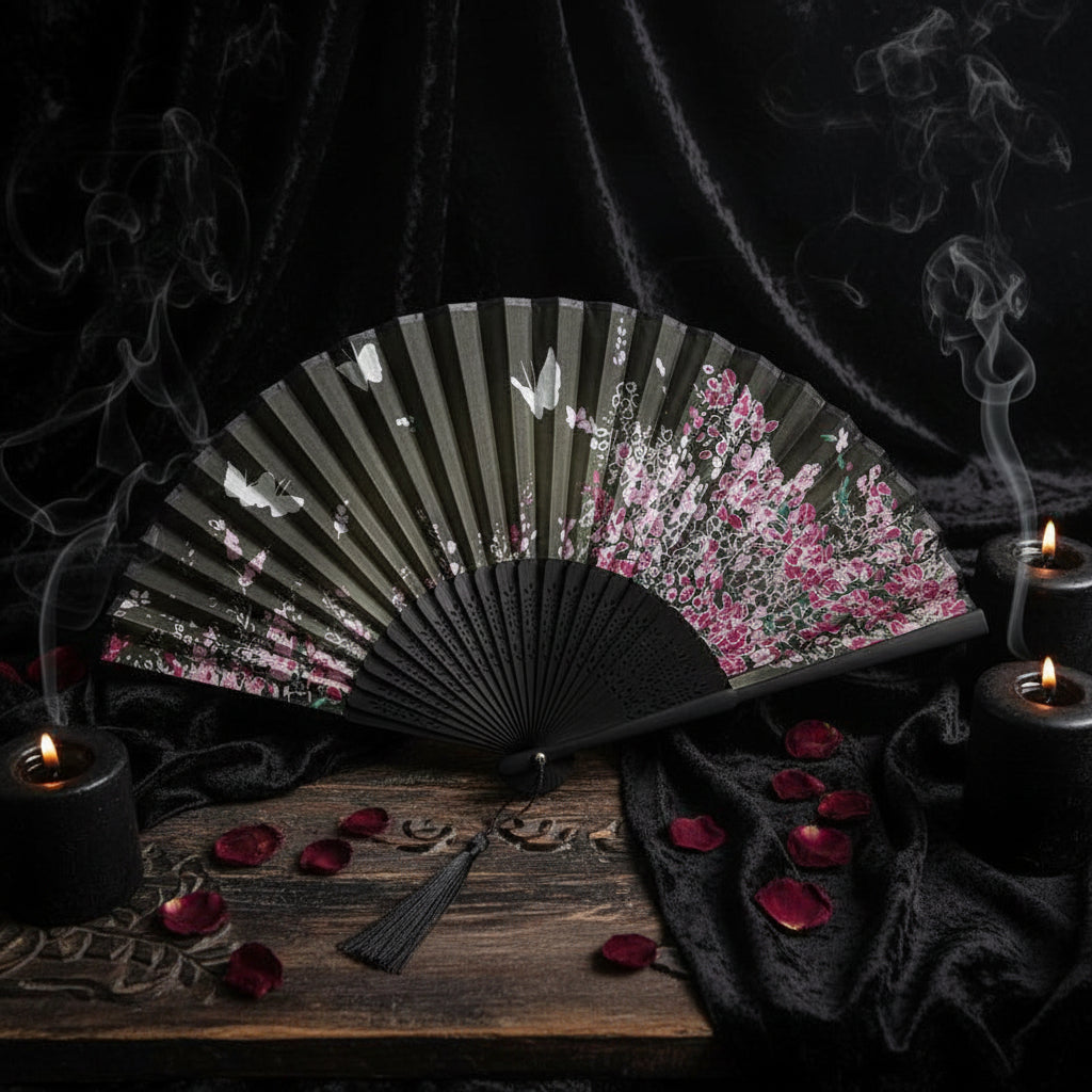 Decorative fan with floral design on a white background with pink flowers.