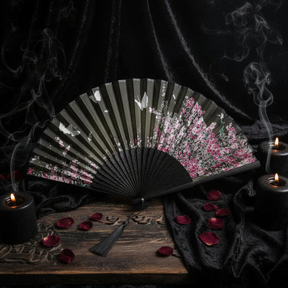 Decorative fan with floral design on a white background with pink flowers.