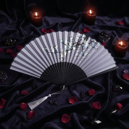 Black folding fan with floral design on a white background with pink flowers