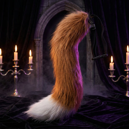Brown furry tail with a black strap on a white background