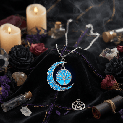 Silver crescent moon necklace with tree of life design, glowing blue in dark.