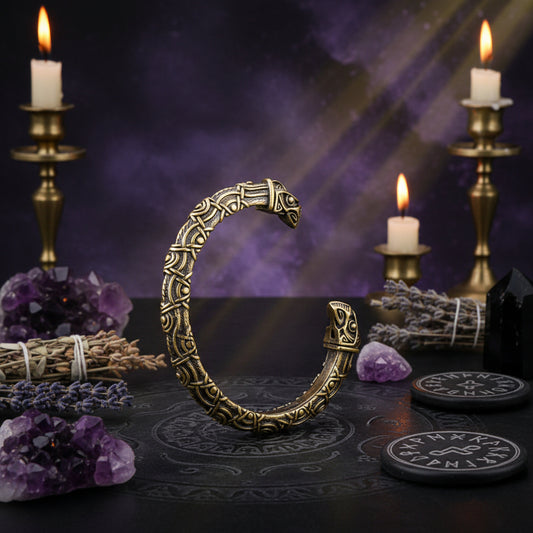 Decorative metal ring with intricate designs on a red textured background
