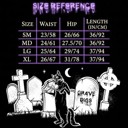 Size reference chart with waist, hip, and length measurements in inches for sizes SM through XL, plus a black-and-white Halloween graveyard illustration below with tombstones and a cat playing a violin.